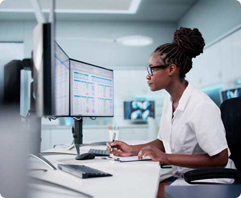 Healthcare professional managing clinical records at a workstation